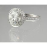 18ct white gold diamond halo ring with diamond set shank. Estimated diamond weight 1.2cts. Ring size