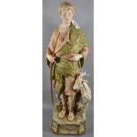 Royal Dux Art Nouveau porcelain figure of a shepherd with his goat standing on a naturalistic