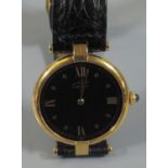 Cartier 9ct gold ladies quartz wristwatch having black face with Roman numerals on original