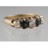 Sapphire and diamond five stone ring set in yellow metal. Ring size L & 1/2. Approx weight 2.1