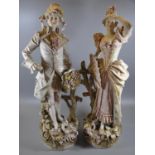 A pair of Royal Dux porcelain figurines of a young gallant and his lady dressed in 18th Century