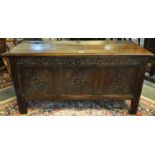 18th Century Welsh oak coffer, the moulded top with 'H' shaped hinges, above a carved foliate frieze