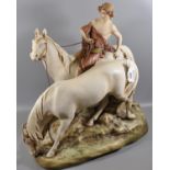 A Royal Dux Art Nouveau porcelain figure group of two horses, one with a young lady sitting astride,