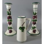 Pair of Llanelly pottery baluster shaped candlesticks painted in the style of Shufflebotham with