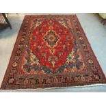 Red and blue ground Persian Surok carpet decorated with central lozenge medallions, flanked by