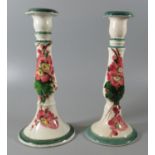 Pair of Llanelly pottery baluster shaped candlestick painted in the manner of Shufflebotham with