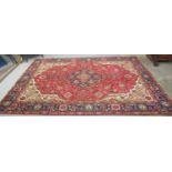 Large red ground Persian Najabad carpet with floral and foliate decoration and borders. 260 x