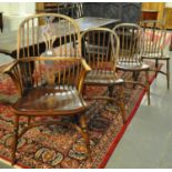 A set of four beech and elm Windsor and hoop spindle back kitchen chairs on crinoline stretchers. (3