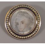 Gold framed memorial brooch with painted portrait within seed pearl border, the back with glazed