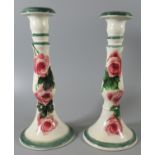 Pair of Llanelly pottery Shufflebotham decorated baluster shaped candlesticks painted with tea roses