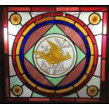 Two 19th Century stained glass panels, framed, each depicting birds to the central design. 57 x 60cm
