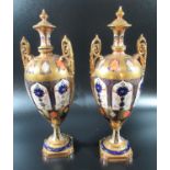 Pair of Royal Crown Derby bone china Imari two handled lidded vases. 32cm high approx. (B.P. 21% +
