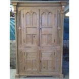Modern pine kitchen cupboard, the geometric and moulded cornice above two blind panelled doors,