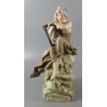Royal Dux Art Nouveau porcelain figure of 'Loreley' modelled with a harp on a rocky outcrop. 31cm