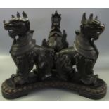 Indo-Burmese stained carved wooden triform censer stand in the form of three standing temple