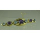 18ct gold bar brooch set with amethyst and aquamarine. Length 60mm. Approx weight 15 grams. (B.P.