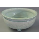 Chinese celadon glazed bowl with flat everted rim, the sides with wave like sgraffito decoration, on