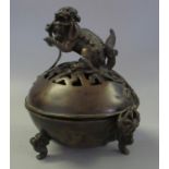 Chinese bronze koro and cover, the pierced dome cover surmounted by a dragon dog, the base on