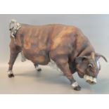 Large art pottery study of a bull appearing to have an impressed monogram, 53cm long approx (B.P.