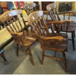 A set of four 20th Century stained spindle back kitchen elbow or armchairs on turned legs and