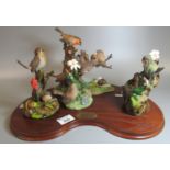 Danbury Mint 'A Robin for all Seasons' by Ann Richmond on kidney shaped mahogany finish base.