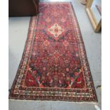 Full pile blue ground Persian Surok runner with multi-coloured petal borders, 288 x 116cm approx. (