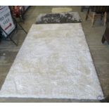 Modern ivory ground 'Indulgence' rug.150 x 240cm approx. Together with a Tungsten silvered shag pile