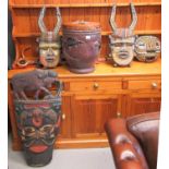 A collection of carved and wooden tribal art items to include; drum with lizard decoration, masks