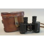 Pair of probably British military binoculars or field glasses in original leather case, bearing