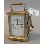 Small French brass carriage clock with full depth Roman enamel dial, with keys, case 114cm high