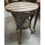 Late 19th/early 20th Century cast iron pub table having pierced scrollwork and mask head