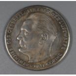 White metal medallion featuring a bust of Reichsmarshell Goering with various text relating to the