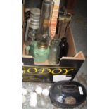 Box containing three vintage oil lamps, vintage bottles, a small hoist in a box, a charming