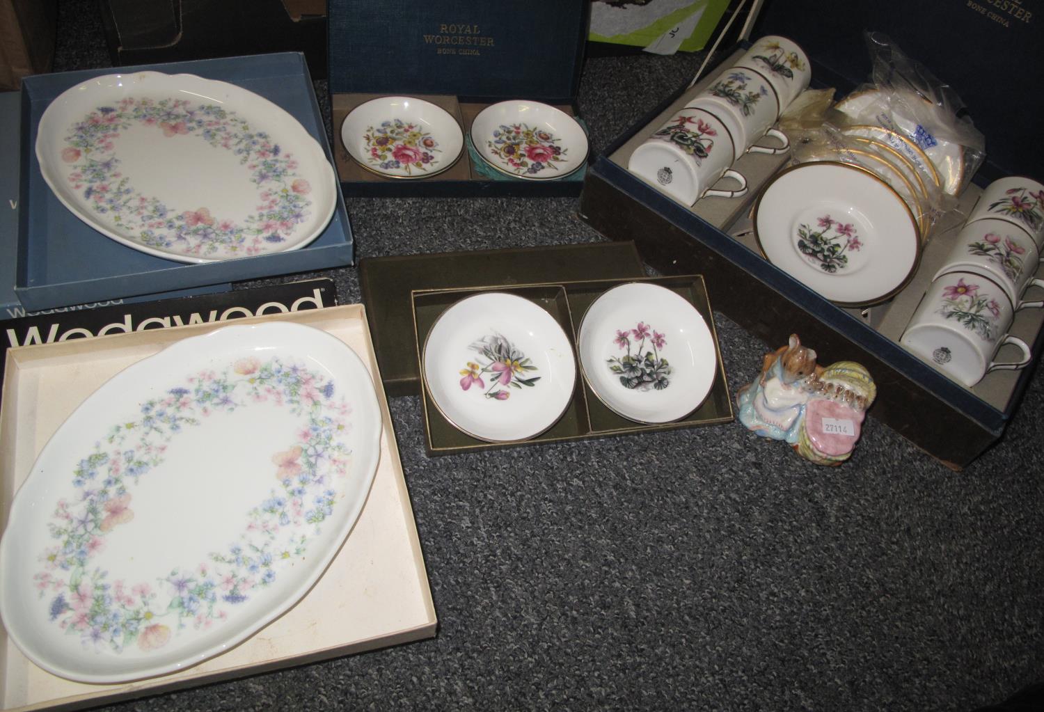 Box containing a boxed set of Royal Worcester coffee cups and saucers decorated with spring