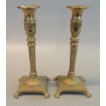 Pair of 19th Century brass candlesticks on square bases with paw feet. 24cm high approx. (2) (B.P.
