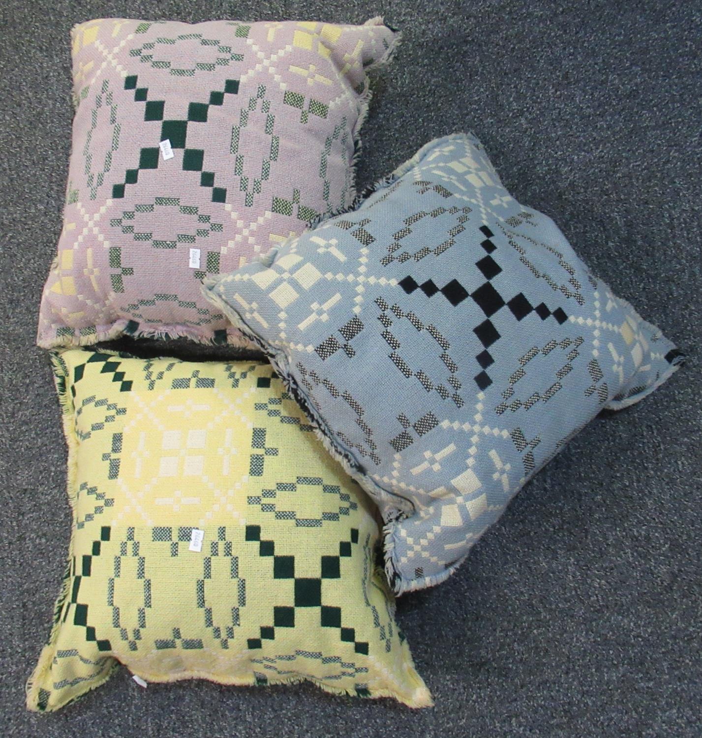 Three woollen Welsh tapestry cushions in different colours. (3) (B.P. 21% + VAT)