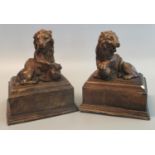 Pair of antiqued loaded plaster bookend type studies of male lions with front paw upon ball on