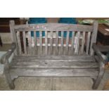 Weathered probably teak set of garden furniture to include; two elbow chairs, open arm bench and