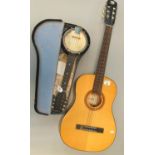 Six string acoustic guitar, the label to the interior marked KC225. Together with a small banjo