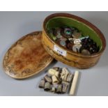 An Italian leather box of oval form comprising assorted thimbles, mother of pearl buttons etc. (B.P.