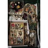 Green crate of assorted costume jewellery to include; dress rings, earrings, brooches, beads,