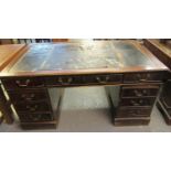 Distressed mahogany knee hole desk having leather inset top in very poor condition above a bank of