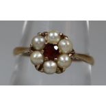 9ct gold seed pearl and garnet flowerhead design dress ring. 2.4g approx. (B.P. 21% + VAT)