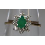 9ct gold flower head design dress ring, set with green central stone and small diamonds. 1.5g