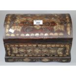 Naive Indian design mother of pearl inlaid, dome top casket, the interior revealing amber coloured