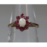 9ct gold opal and red stone dress ring, probably garnet. 1.4g approx. (B.P. 21% + VAT)