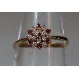 9ct gold flower head design ring, set with clear and red stones. 1.6g approx. (B.P. 21% + VAT)