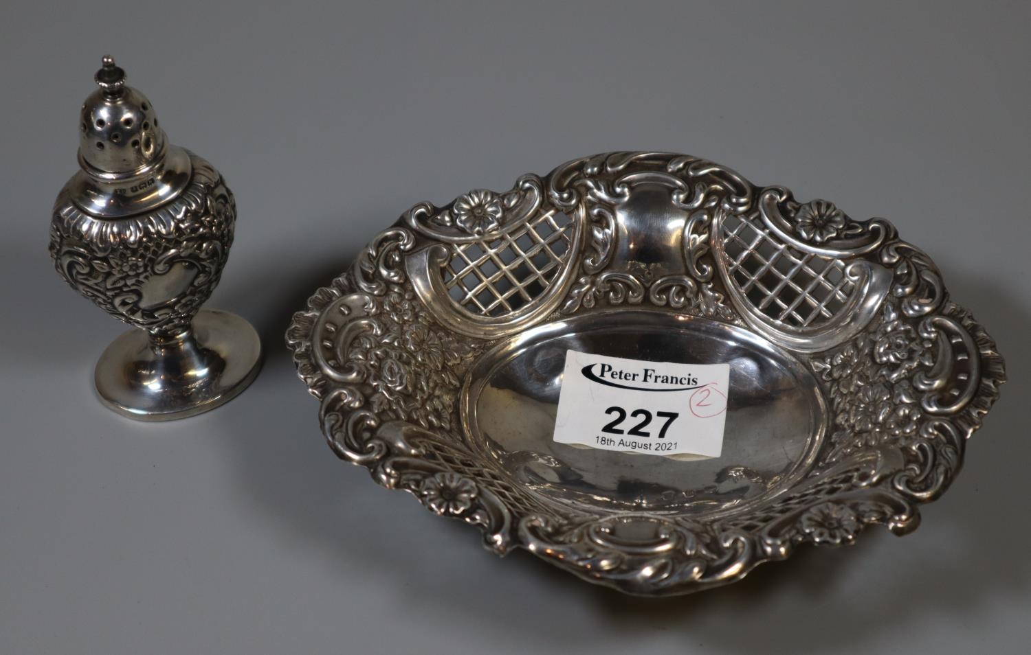 Early 20th Century silver repousse and pierced bon-bon dish on ball feet, together with a similar