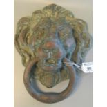 Heavy cast metal door knocker in the form of a lion mask with ring. 23 x 20cm approx. (B.P. 21% +