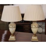 Pair of modern cream ground urn shaped vases with shades, having gilt foliate decoration on square